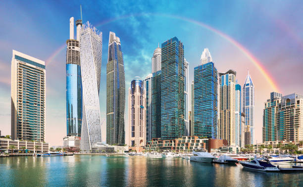 Skyscrapers in Dubai Marina under a rainbow, reflecting the allure of freelancing benefits in the city.