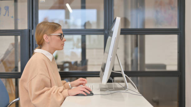 A person in an office using a computer, possibly researching UnionPay card usage in Dubai.