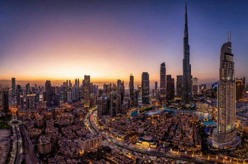 Panoramic view of Dubai cityscape at sunset, highlighting the Burj Khalifa and vibrant urban development.